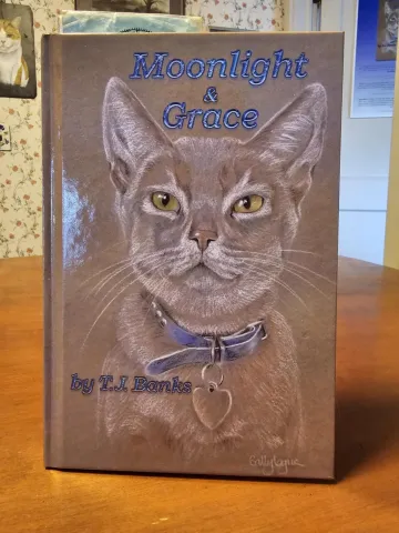 Head and shoulders image of cat on book cover.