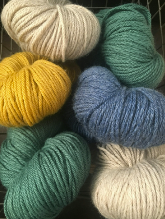 Six balls of yarn in earth tones.